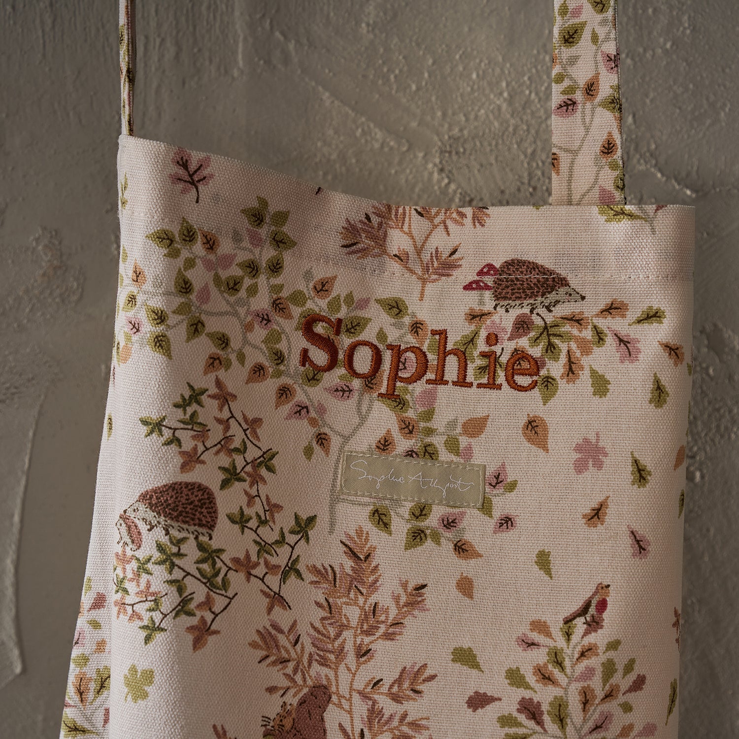 Close up of Sophie Allport's Woodland Friend's Adult Apron which has been personalised to say Sophie