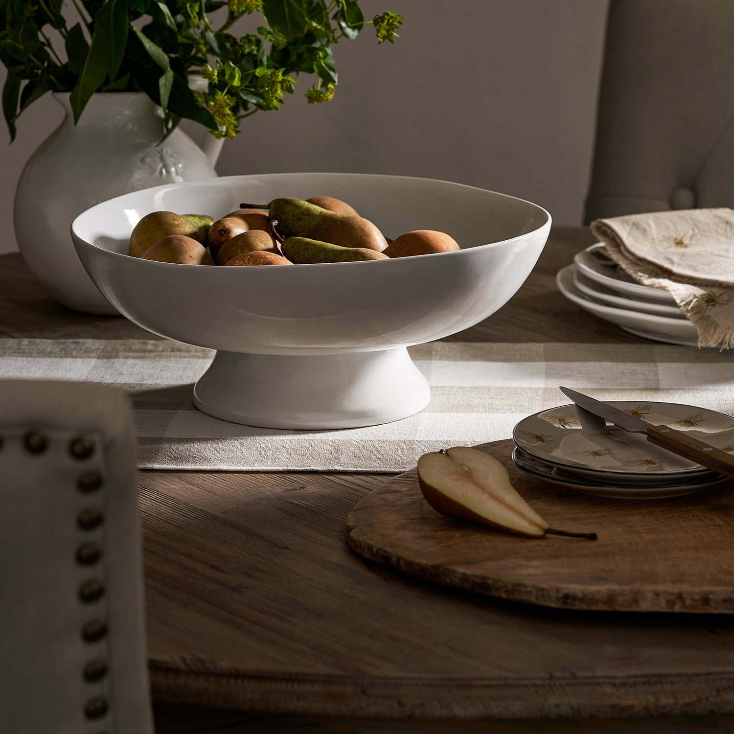 Bees Earthenware Bowl by Sophie Allport filled with pears on a table setting