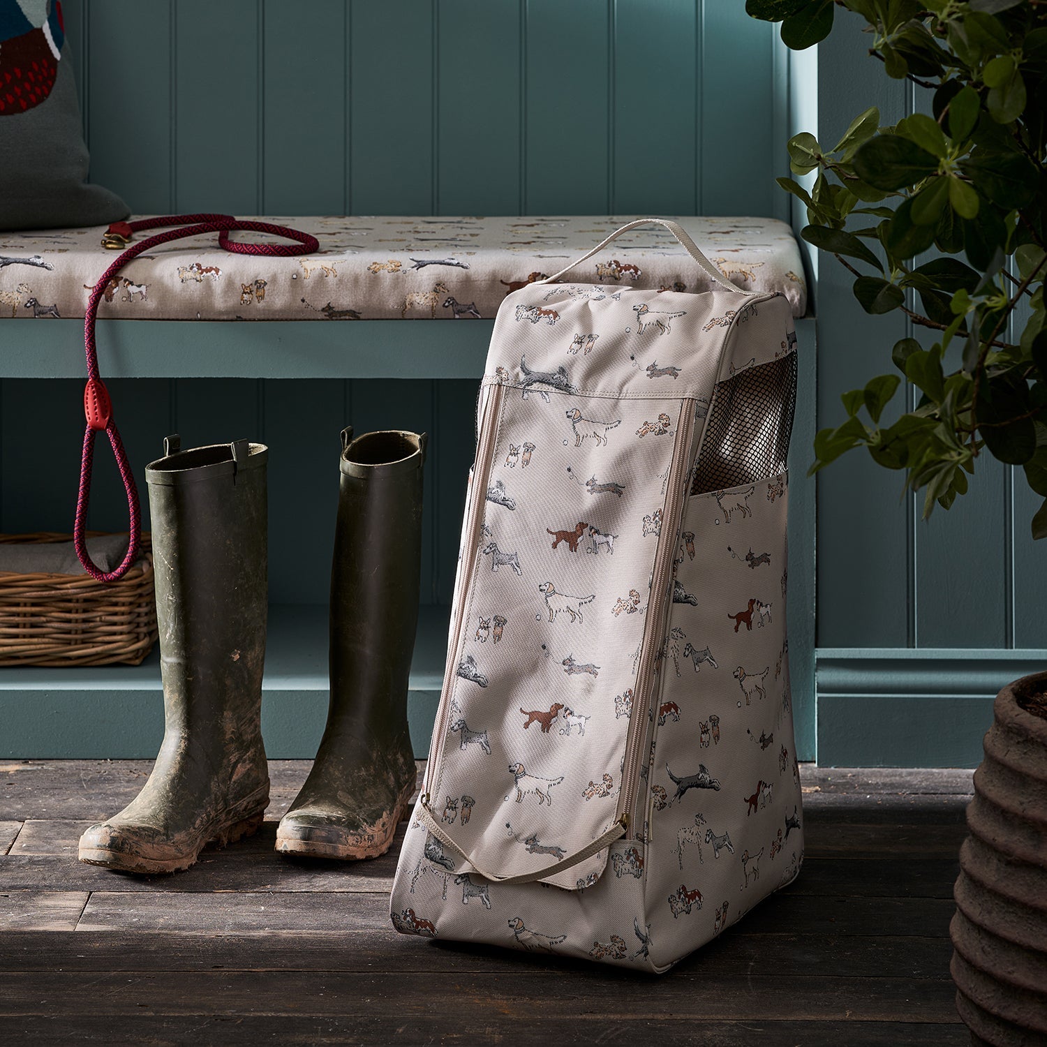 Sophie Allport's Doggy Daycare Boot Bag in boot room next to muddy wellies