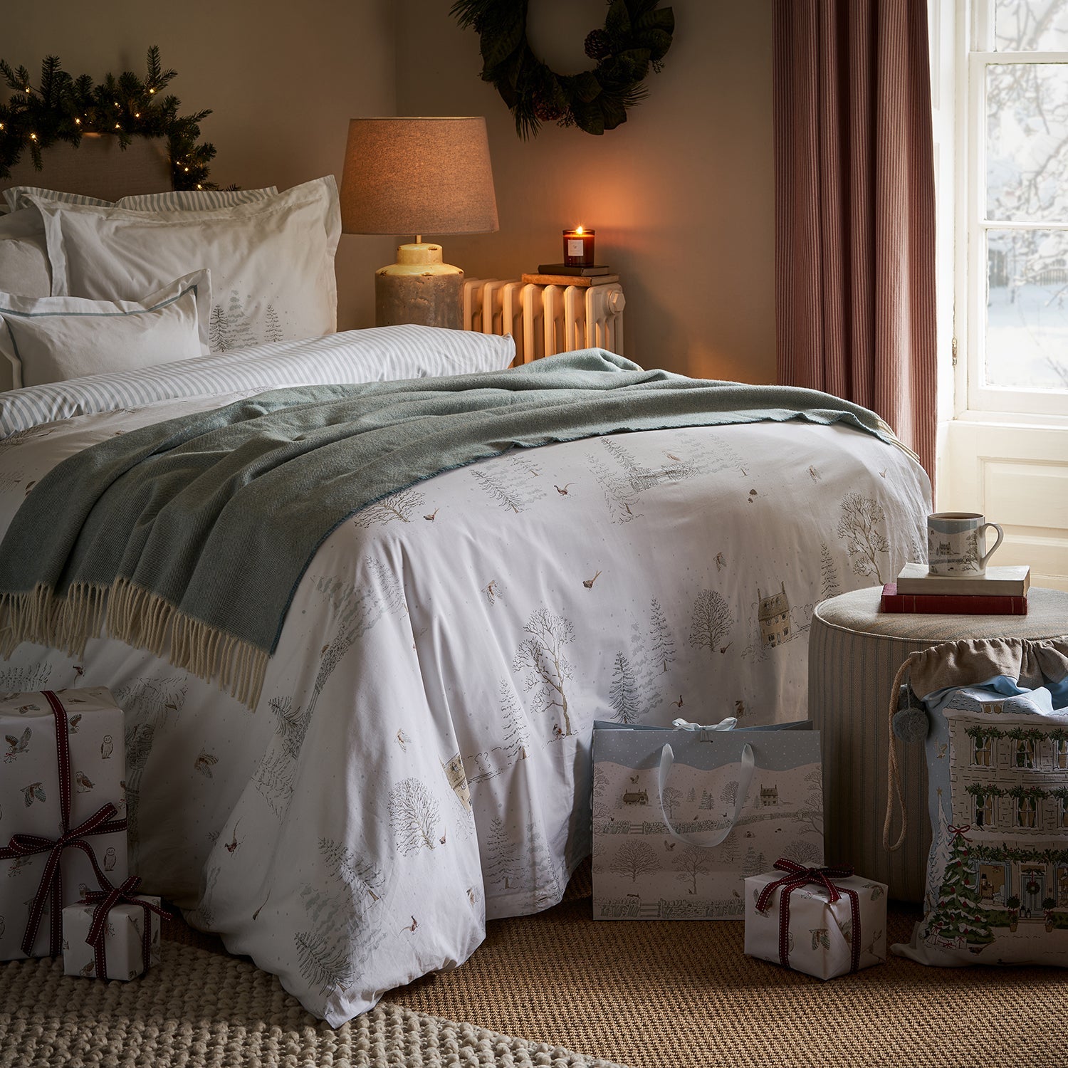 Sophie Allport's Blue Lambswool Throw placed on festive bedding