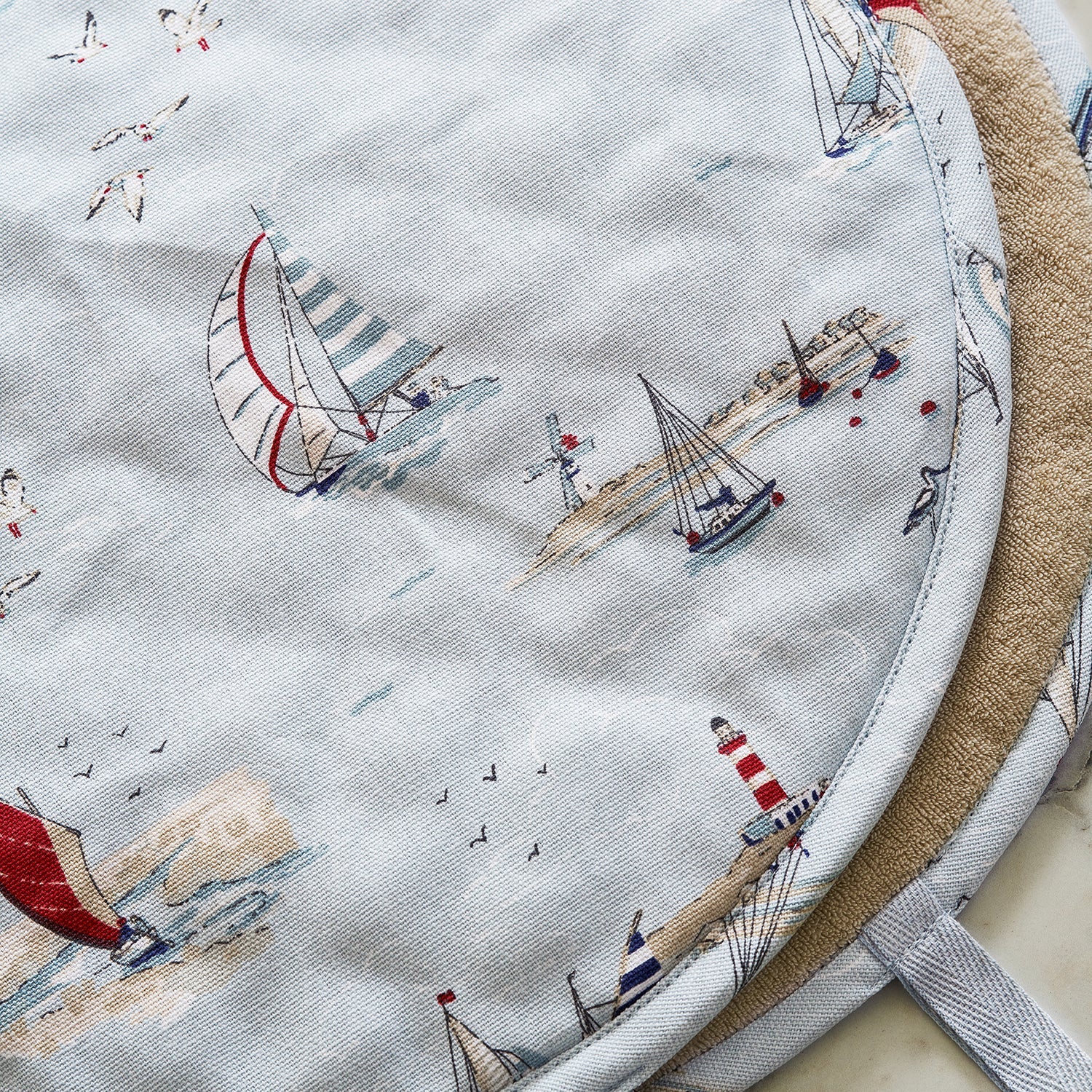 Blue hob covers with coastal sailing boats print by Sophie Allport detail