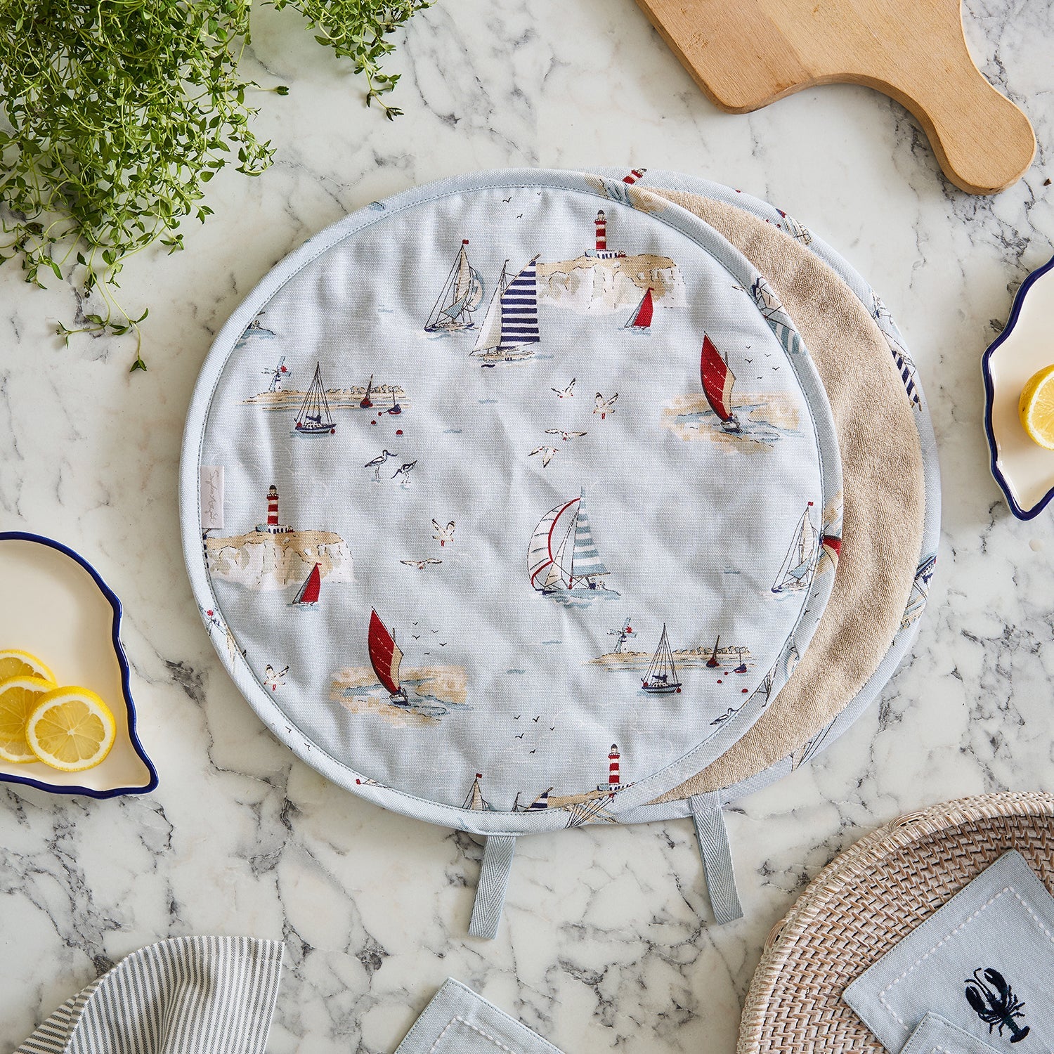 Blue hob covers with coastal sailing boats print by Sophie Allport