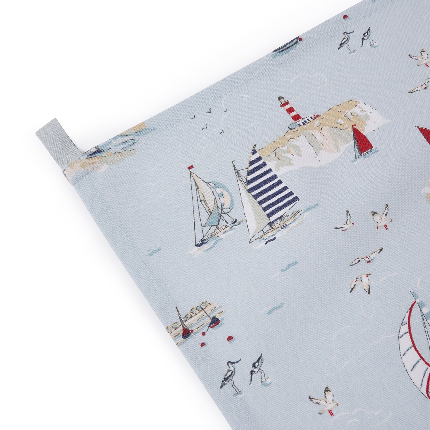 Blue tea towel with coastal boats print by Sophie Allport hanging loop