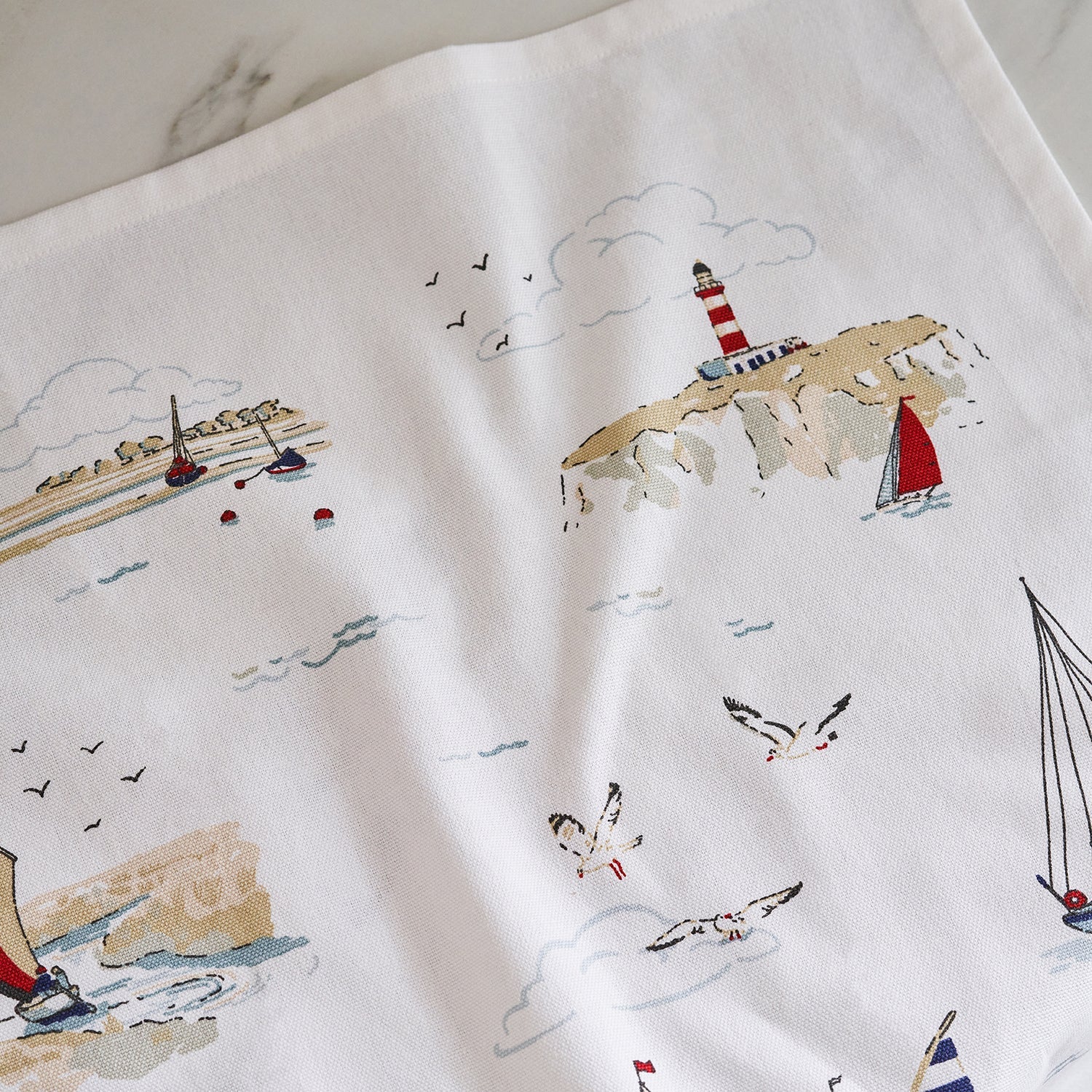 White tea towel with coastal sailing boats by Sophie Allport detail