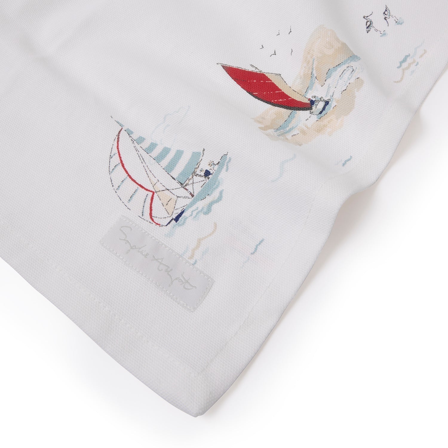 White table runner with coastal sailing boats print by Sophie Allport corner detail