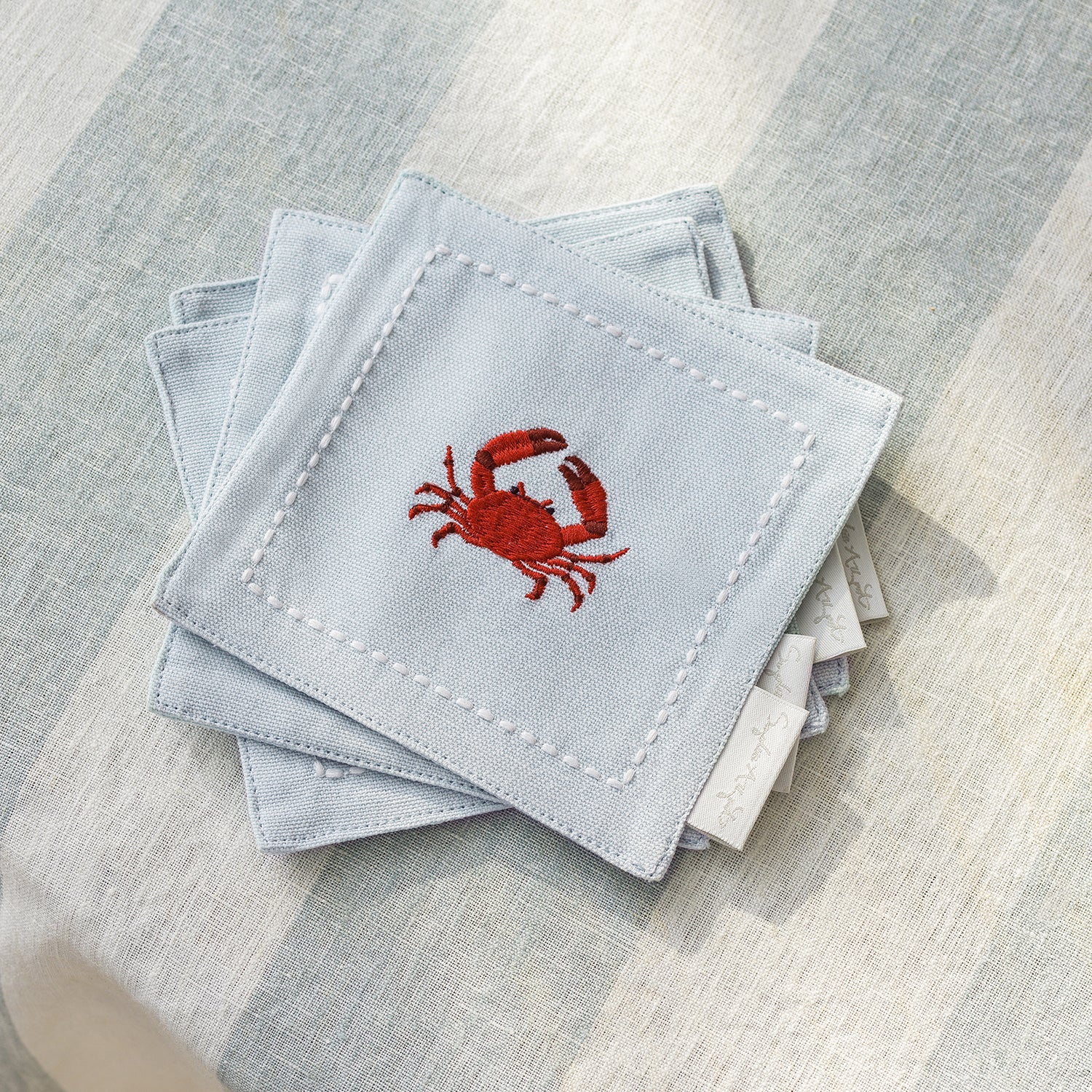 Blue drinks coasters with coastal crab print by Sophie Allport