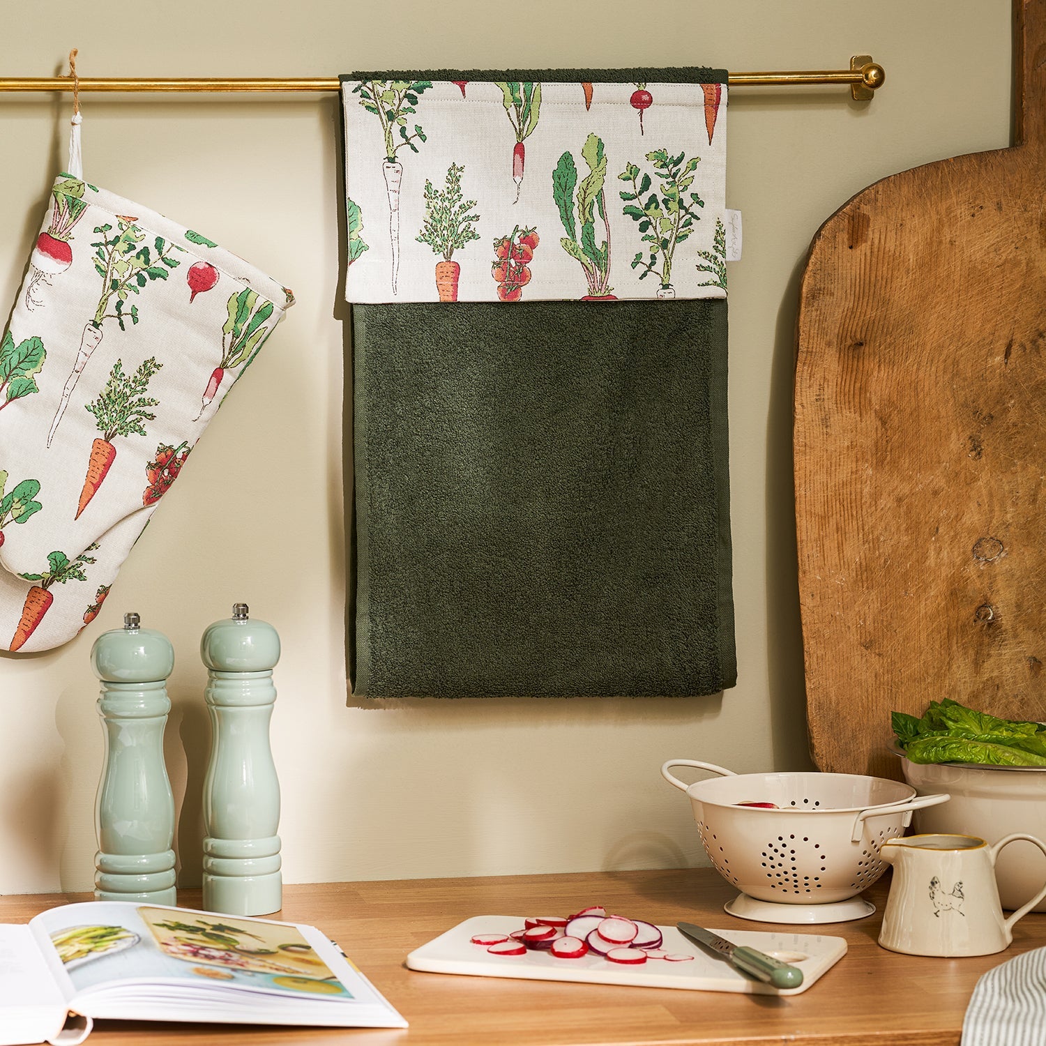 Green roller hand towel with garden vegetables print by Sophie Allport