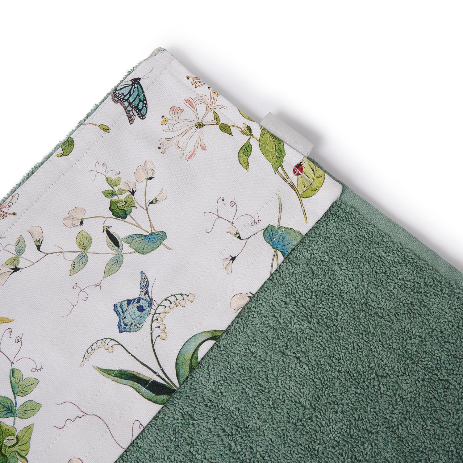 Green roller hand towel with floral print by Sophie Allport tag detail