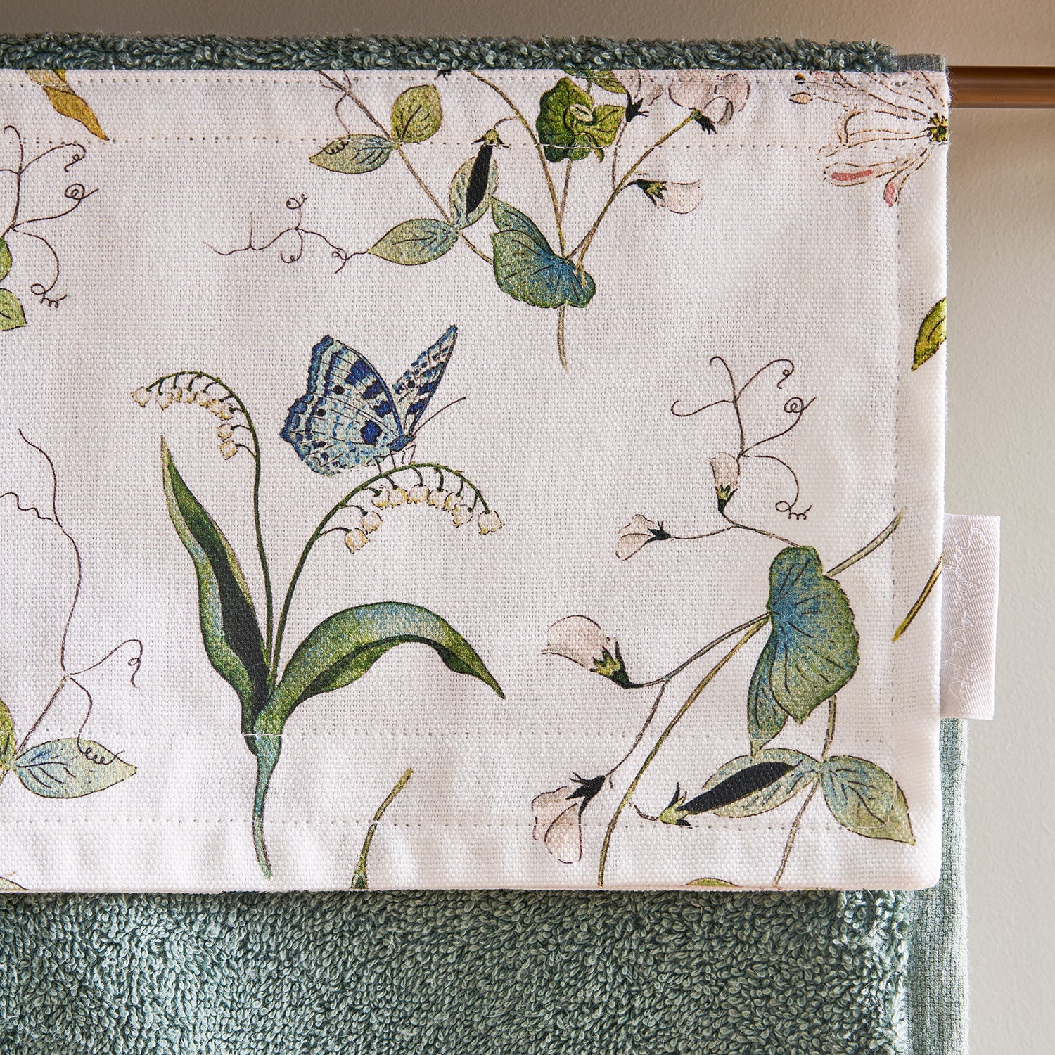 Green roller hand towel with floral print by Sophie Allport detail