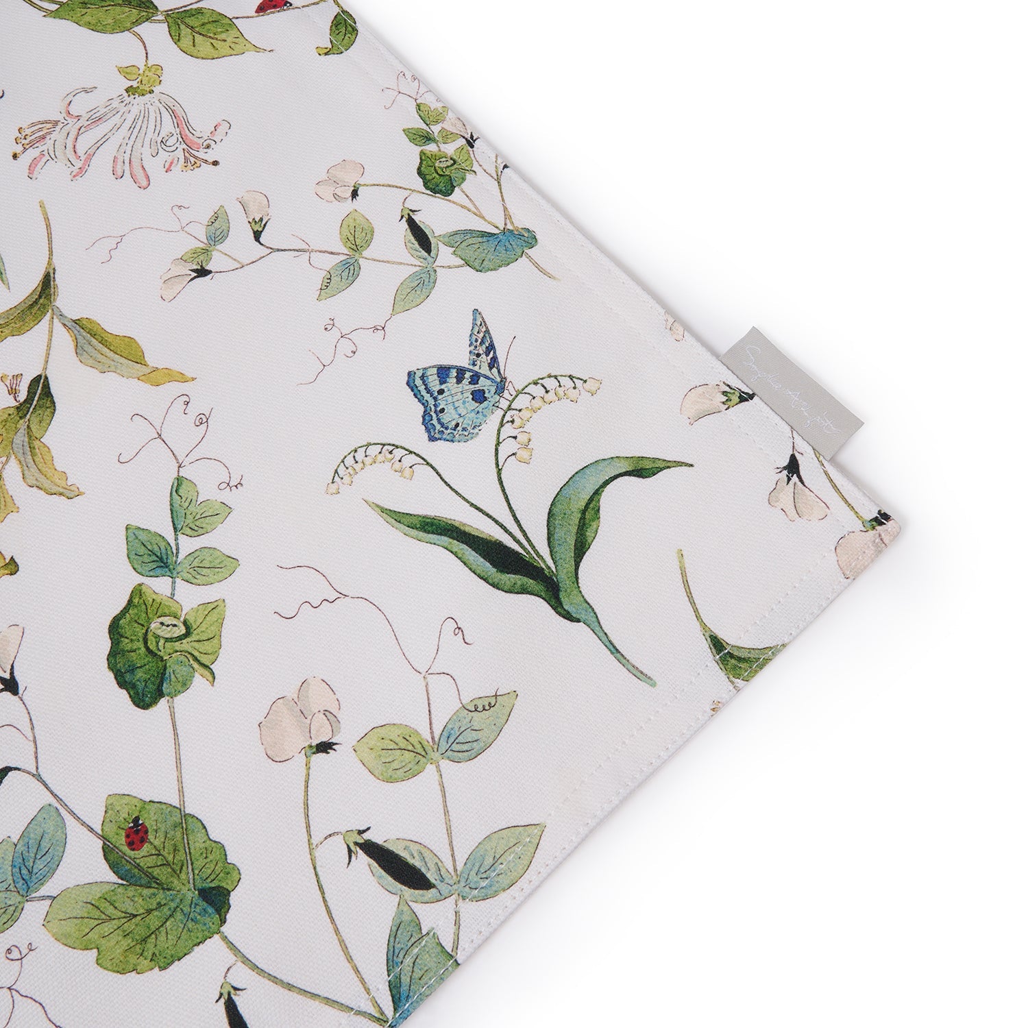 White fabric placemats with floral print by Sophie Allport tag detail