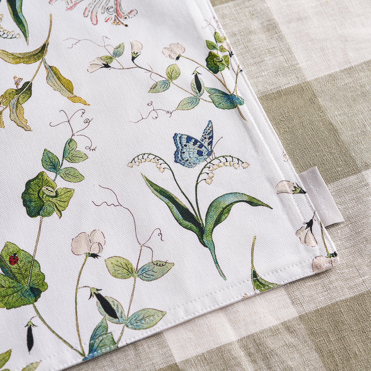 White fabric placemats with floral print by Sophie Allport detail