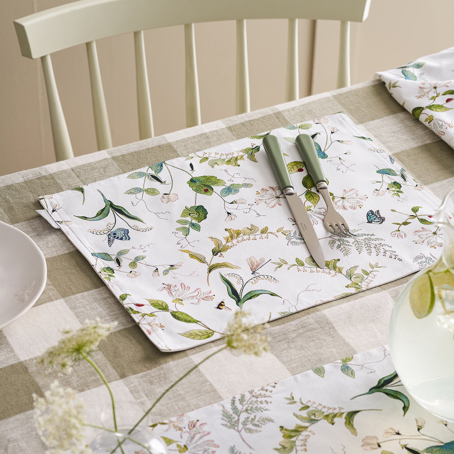 White fabric placemats with floral print by Sophie Allport