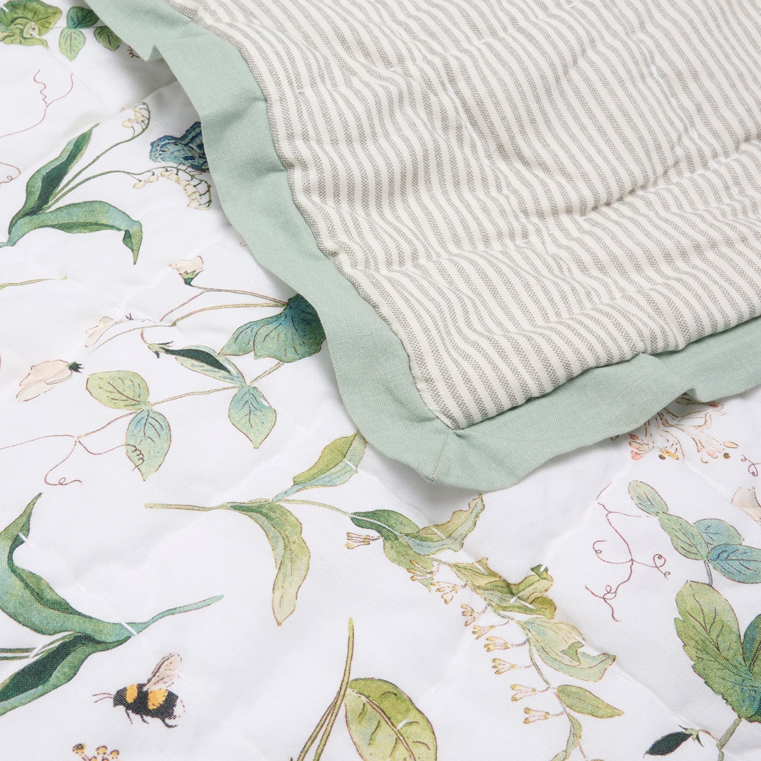 White quilted throw with floral print by Sophie Allport striped reverse