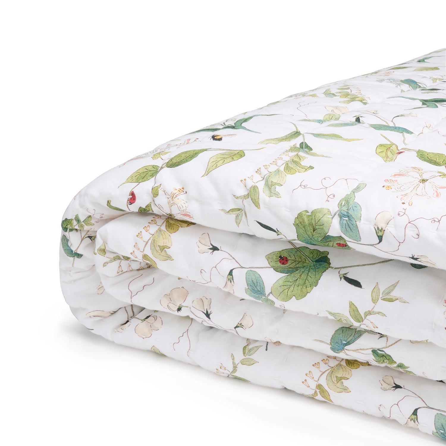 White quilted throw with floral print by Sophie Allport folded