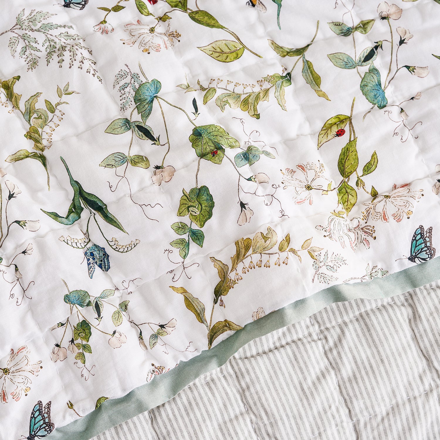 White quilted throw with floral print by Sophie Allport detail