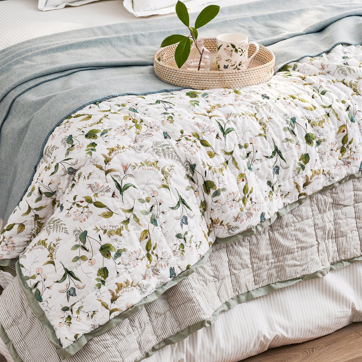 White quilted throw with floral print by Sophie Allport