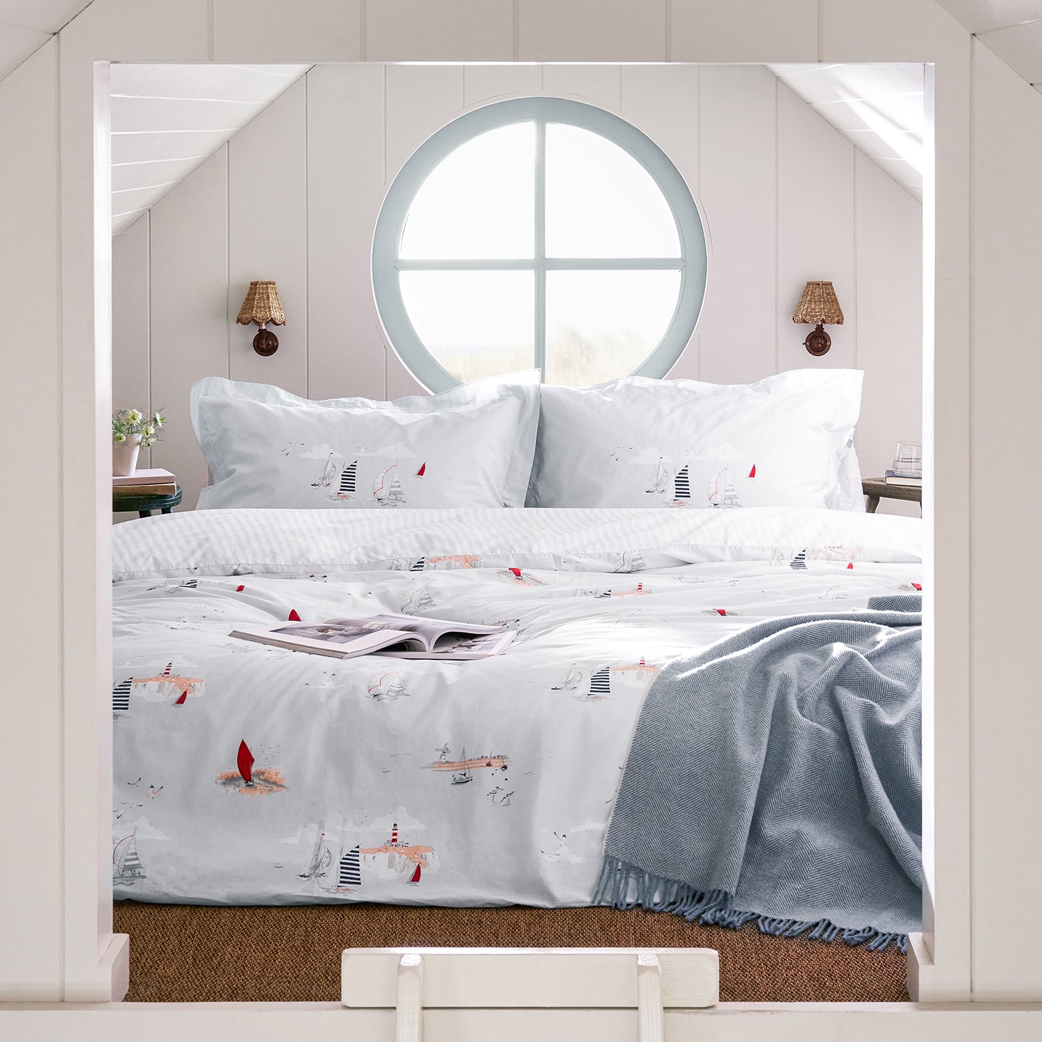 Blue cotton bedding set with coastal print by Sophie Allport