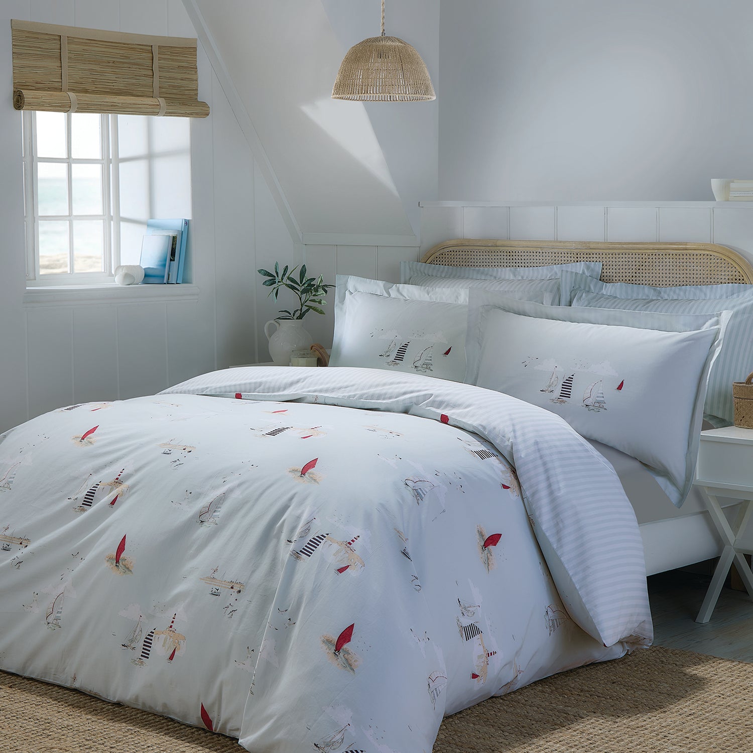 Blue cotton bedding set with coastal print by Sophie Allport bedroom scene