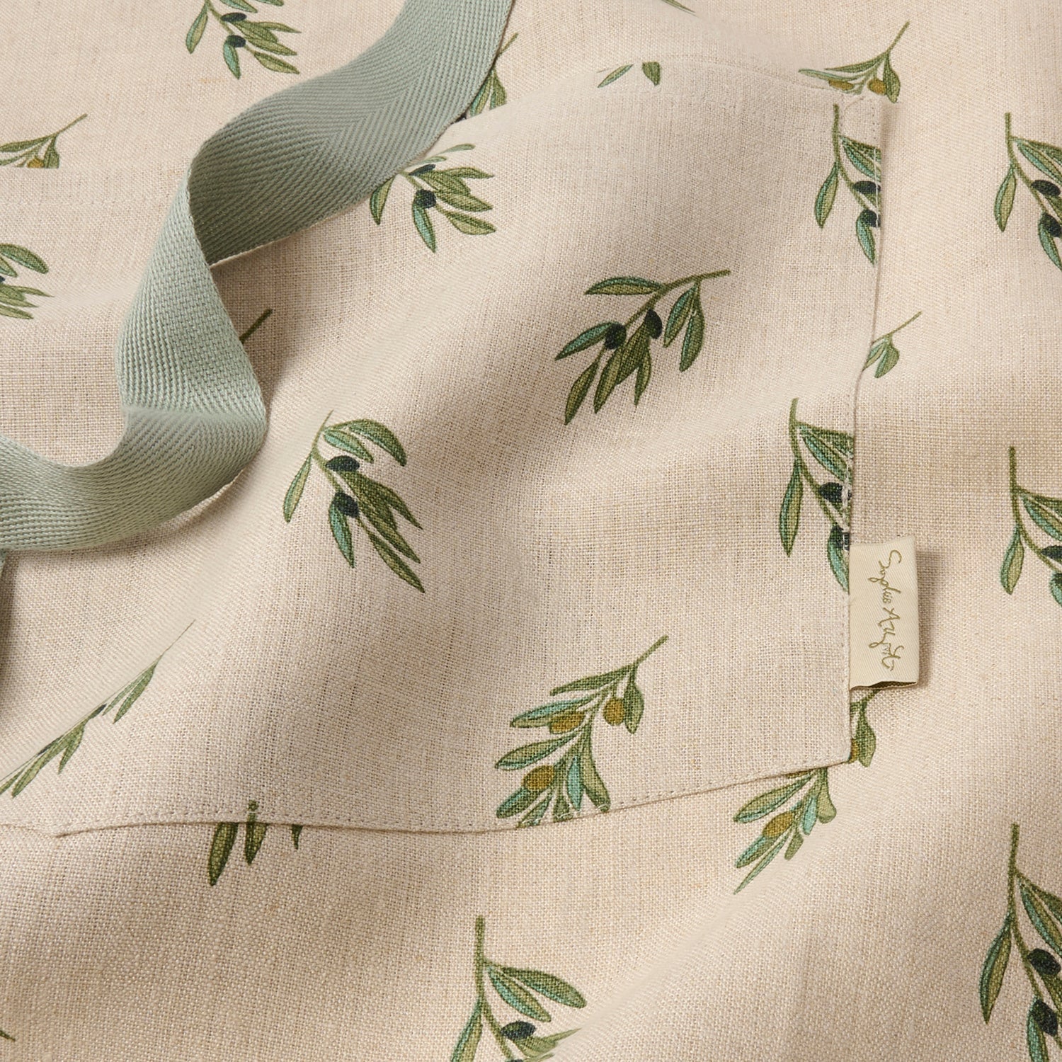 Linen adult apron with olive print by Sophie Allport pocket detail