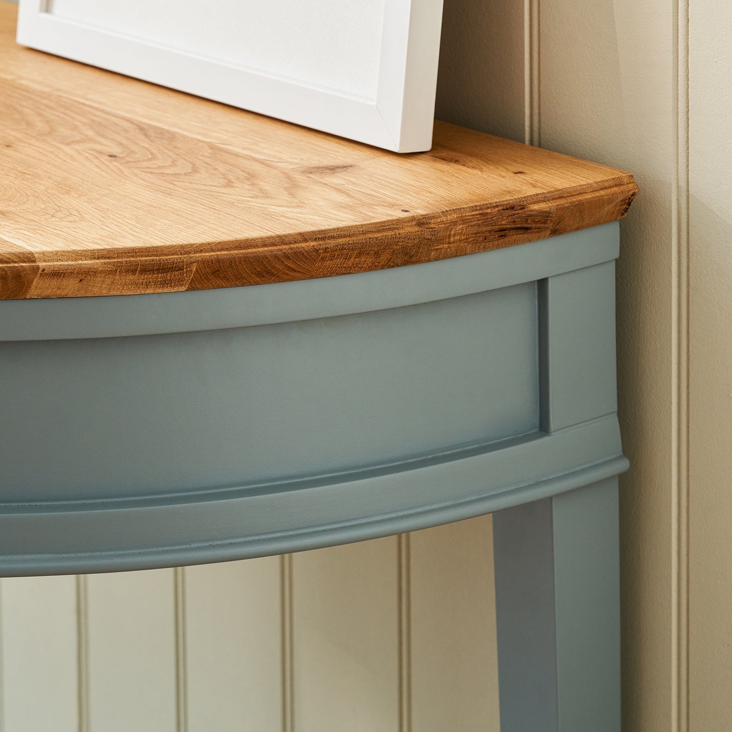 Blue halfmoon console table with oak top by Sophie Allport moulding detail