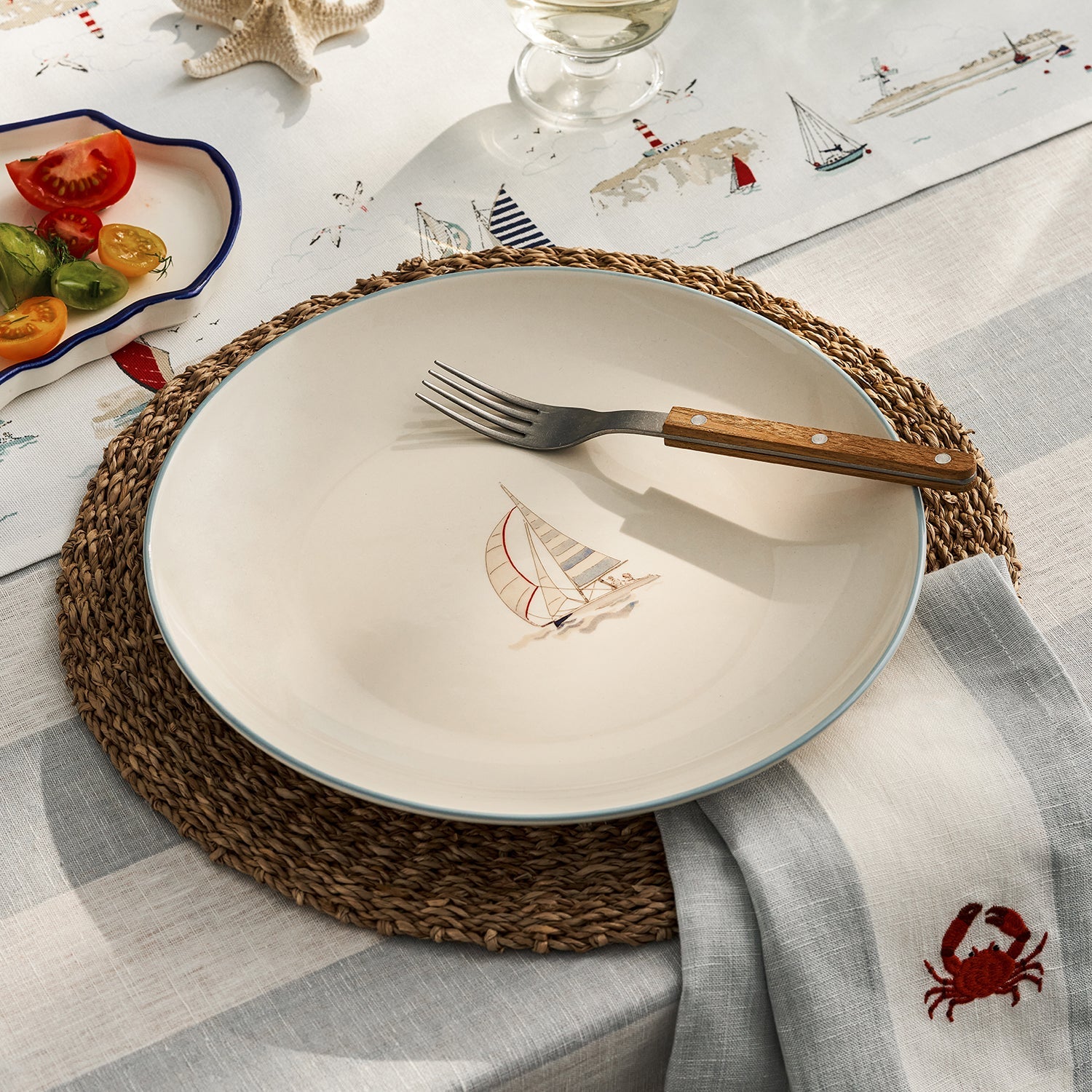 Stoneware dinner plate with red sailing boat by Sophie Allport