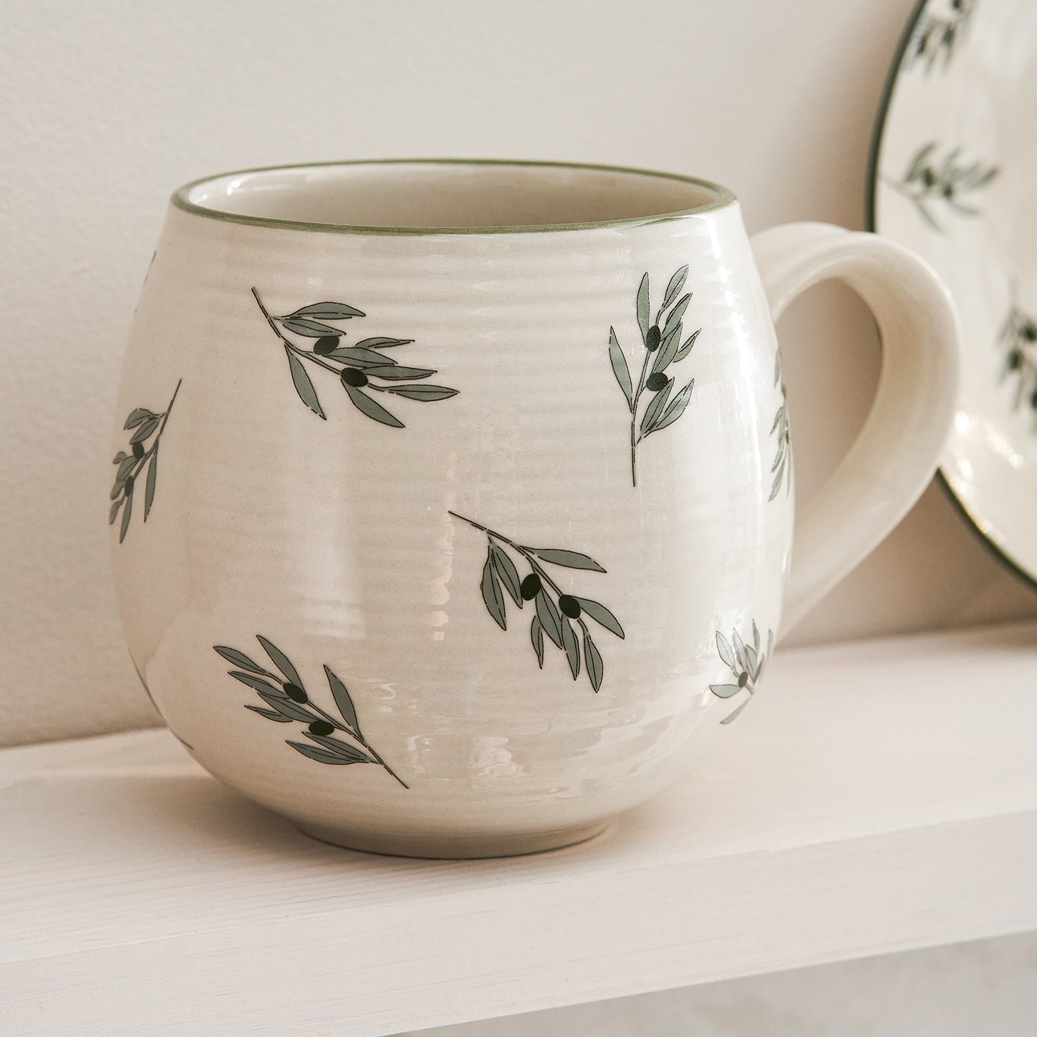 Stoneware mug with olive print by Sophie Allport detail